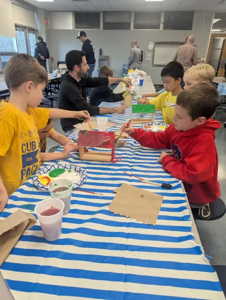 Painting birdhouses at a den meeting
