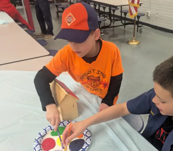 A Tiger painting a birdhouse at a den meeting